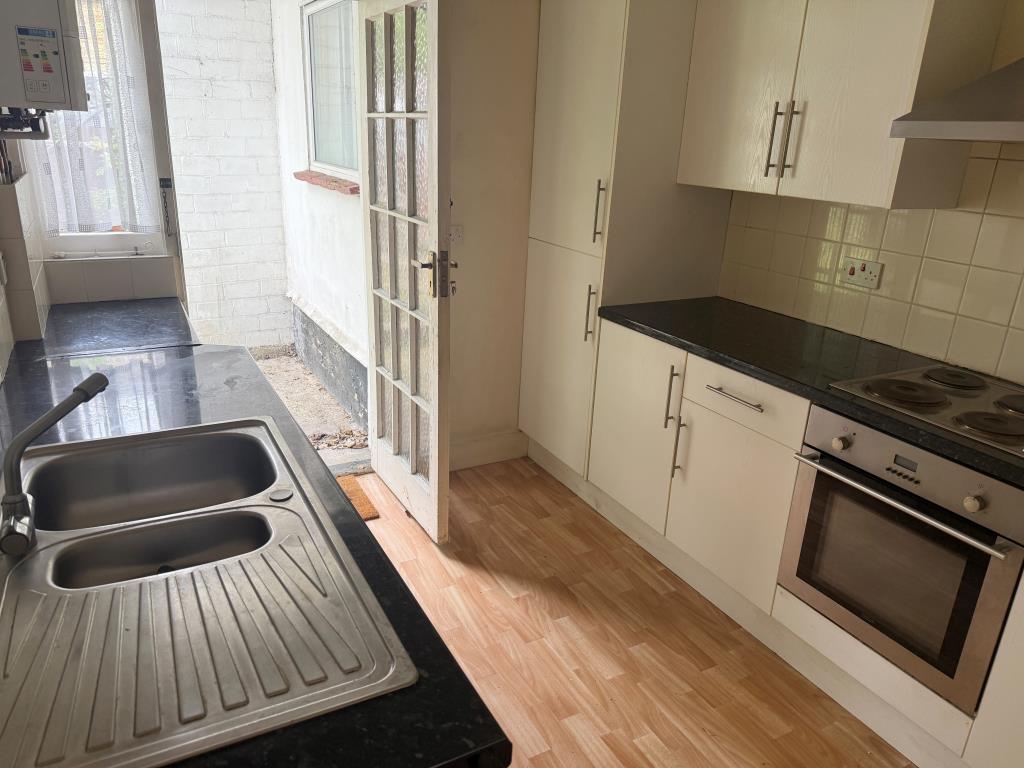 Lot: 19 - FREEHOLD GROUND RENTS WITH VACANT FLAT AND GARAGE - Kitchen with door to rear garden